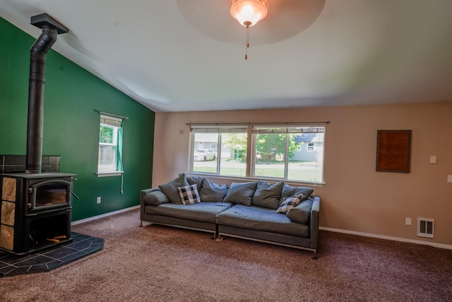 38823 N Newport Hwy, Elk, WA 99009 - living room featuring a wood stove, vaulted ceiling, ceiling fan, and carpet floors