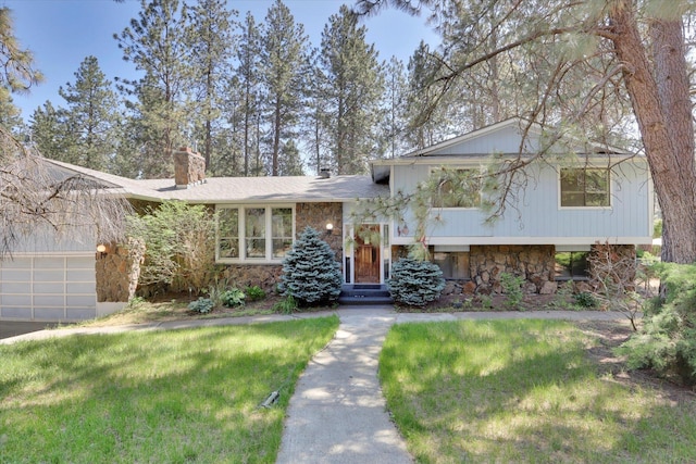 4717 S Skipworth Rd, Spokane Valley, WA 99206 - tri-level home featuring stone siding, a chimney, a front yard, and a garage