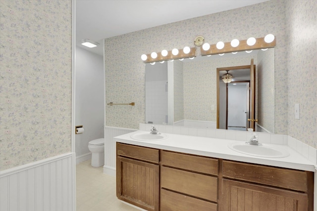 4717 S Skipworth Rd, Spokane Valley, WA 99206 - full bathroom with wallpapered walls, double vanity, a wainscoted wall, and tile patterned floors