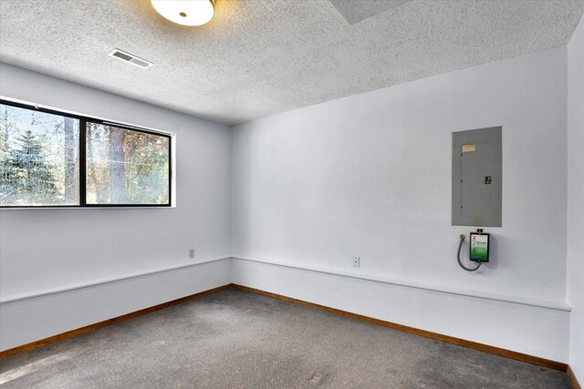 4717 S Skipworth Rd, Spokane Valley, WA 99206 - carpeted empty room featuring electric panel and a textured ceiling