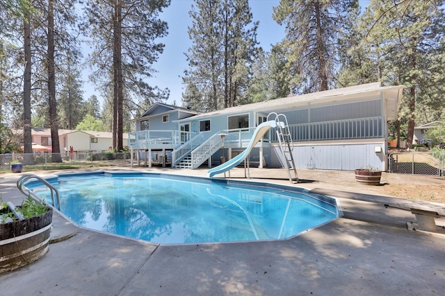 4717 S Skipworth Rd, Spokane Valley, WA 99206 - view of pool with a wooden deck, a water slide, stairway, and a patio area