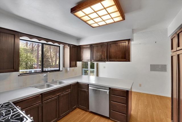 4717 S Skipworth Rd, Spokane Valley, WA 99206 - kitchen featuring stainless steel dishwasher, light wood-style flooring, tasteful backsplash, and light countertops
