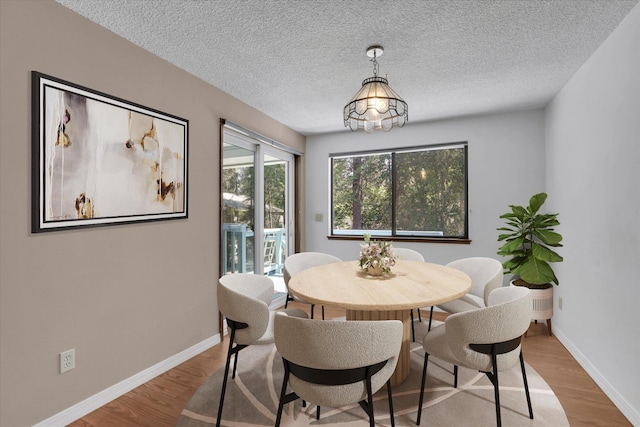 4717 S Skipworth Rd, Spokane Valley, WA 99206 - dining space featuring wood finished floors and a textured ceiling
