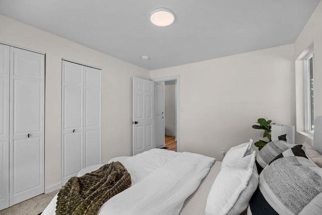 1501 N Lily Rd, Spokane, WA 99212 - bedroom with multiple closets and light carpet