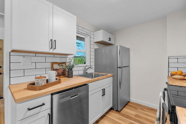 1501 N Lily Rd, Spokane, WA 99212 - kitchen featuring stainless steel appliances, butcher block counters, light wood finished floors, and backsplash