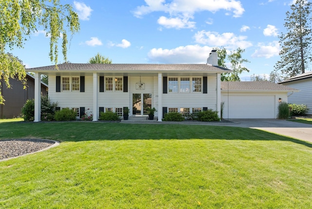 4118 S Stone St, Spokane, WA 99223 - split foyer home with a garage, a chimney, a front yard, and concrete driveway