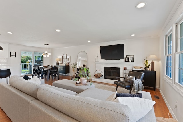 4118 S Stone St, Spokane, WA 99223 - living area featuring a fireplace, recessed lighting, wood finished floors, a chandelier, and ornamental molding