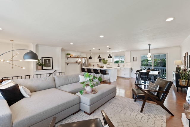 4118 S Stone St, Spokane, WA 99223 - living room featuring light wood-style flooring, recessed lighting, a chandelier, and crown molding