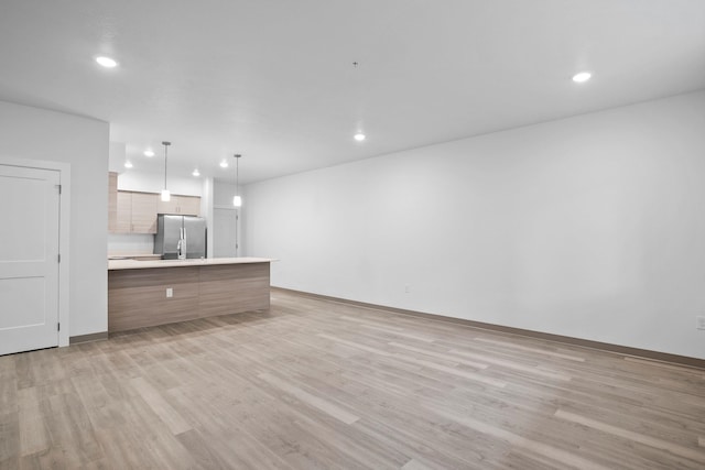 12608 E Nora Ave, Spokane Valley, WA 99216 - unfurnished living room featuring recessed lighting and light wood finished floors