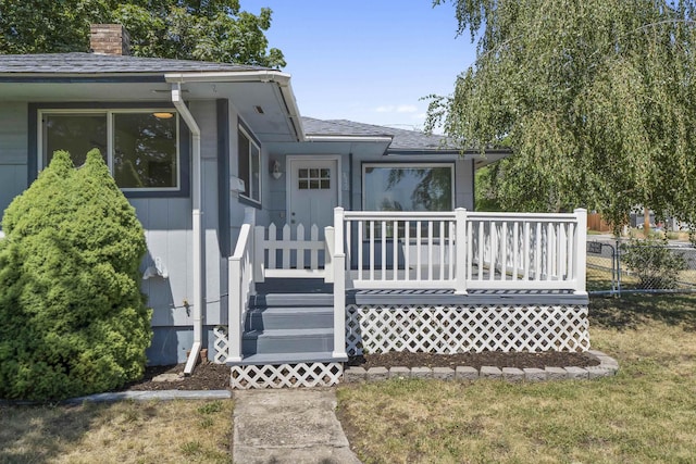 3927 E Fairview Ave, Spokane, WA 99217 - view of front of home with a chimney, a wooden deck, and a shingled roof