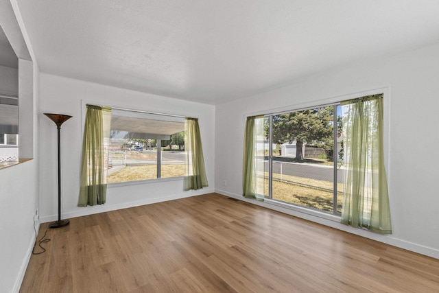 3927 E Fairview Ave, Spokane, WA 99217 - unfurnished room featuring wood finished floors and plenty of natural light