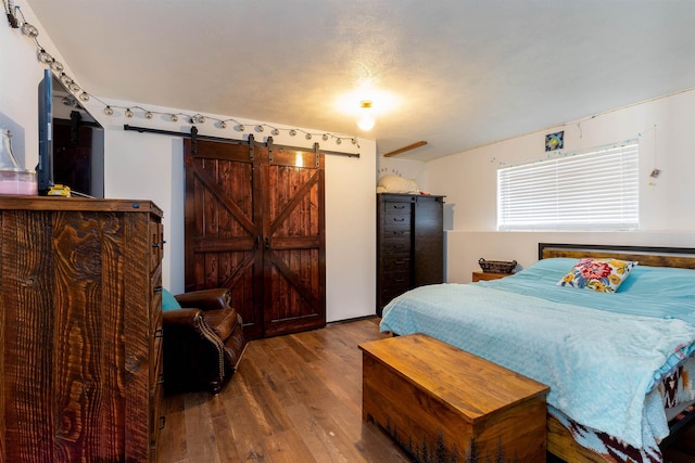 15204 N Chesapeake Rd, Mead, WA 99021 - bedroom featuring a barn door and wood finished floors