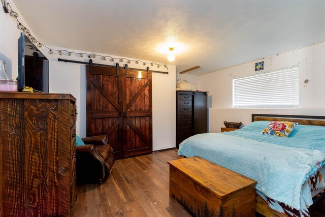 15204 N Chesapeake Rd, Mead, WA 99021 - bedroom with a barn door and wood finished floors