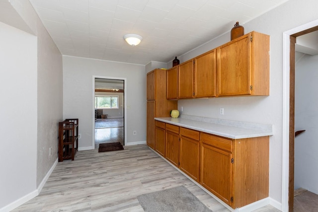 337 Lehigh Hill Rd, Metaline Falls, WA 99153 - kitchen with light countertops, light wood-type flooring, and brown cabinetry