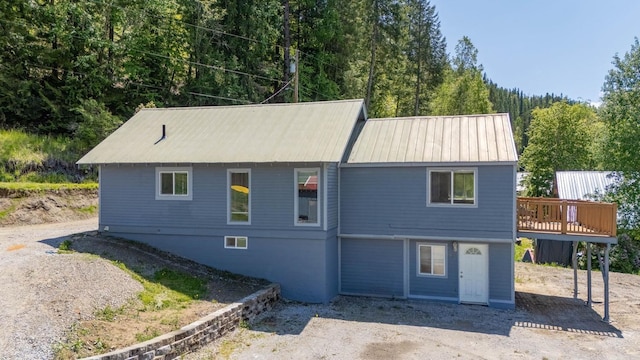 337 Lehigh Hill Rd, Metaline Falls, WA 99153 - view of front of house with a wooden deck, a forest view, and a patio area