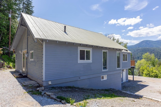 337 Lehigh Hill Rd, Metaline Falls, WA 99153 - view of side of property with a mountain view, a metal roof, a garage, and driveway