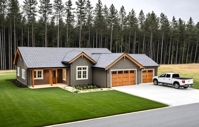 11206 E 27th Ave Lot 10, Spokane Valley, WA 99206 - view of front of house featuring an attached garage, driveway, a front yard, covered porch, and a forest view