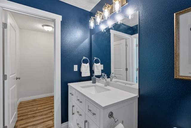 1010 E Montgomery Ave, Spokane, WA 99207 - bathroom with vanity, wood finished floors, and a textured wall