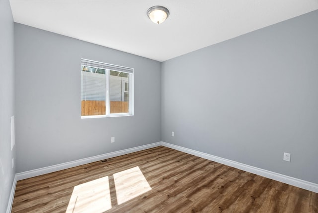1010 E Montgomery Ave, Spokane, WA 99207 - unfurnished room with wood finished floors and baseboards
