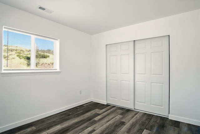 41450 Sunday Bay Rd N, Deer Meadows, WA 99122 - unfurnished bedroom featuring dark wood-type flooring and a closet