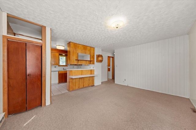 10904 E 26th Ave, Spokane, WA 99206 - unfurnished living room featuring light colored carpet and a textured ceiling