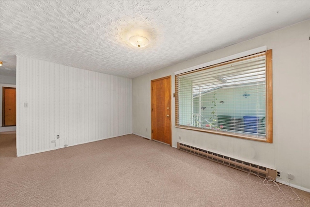 10904 E 26th Ave, Spokane, WA 99206 - carpeted spare room with a textured ceiling and a baseboard heating unit