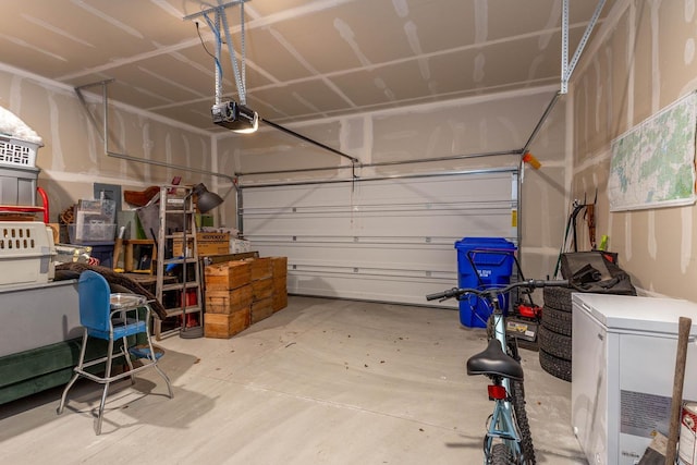 5414 E Bridgeport Ct, Spokane, WA 99217 - garage featuring a garage door opener and refrigerator