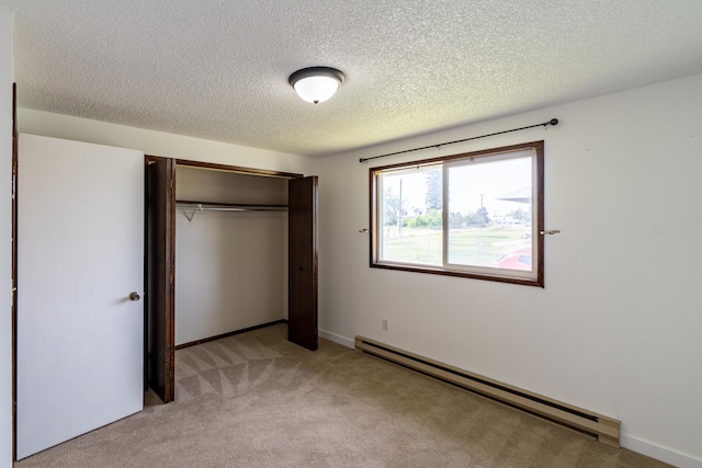 4806 N Drury Rd, Otis Orchards, WA 99027 - unfurnished bedroom with a baseboard radiator, light colored carpet, a textured ceiling, and a closet