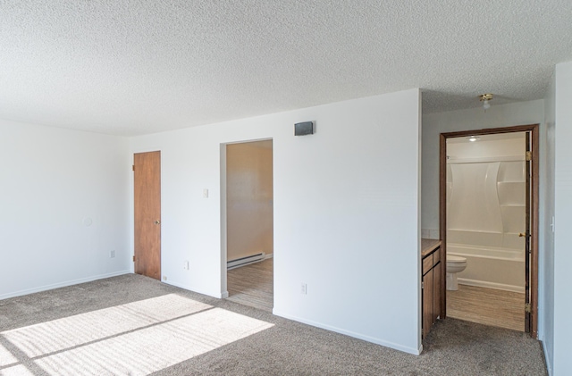 4806 N Drury Rd, Otis Orchards, WA 99027 - unfurnished bedroom with baseboard heating, carpet flooring, a textured ceiling, and ensuite bathroom