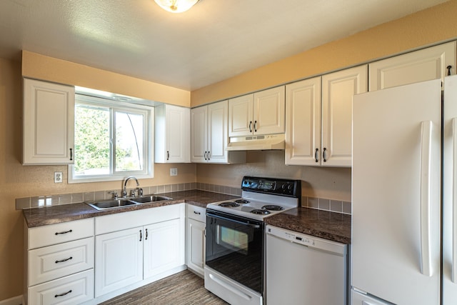 4806 N Drury Rd, Otis Orchards, WA 99027 - kitchen featuring white appliances, under cabinet range hood, dark countertops, and white cabinets
