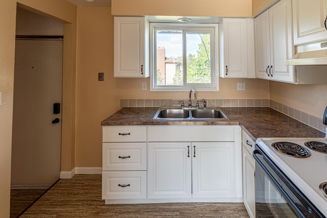 4806 N Drury Rd, Otis Orchards, WA 99027 - kitchen with white range with electric cooktop, under cabinet range hood, dark countertops, white cabinetry, and dark wood finished floors