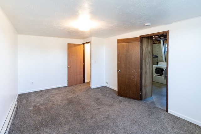 4806 N Drury Rd, Otis Orchards, WA 99027 - unfurnished bedroom with washer / dryer, a baseboard radiator, carpet floors, and a textured ceiling