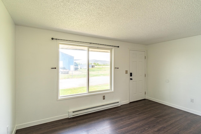 4806 N Drury Rd, Otis Orchards, WA 99027 - empty room with baseboard heating, dark wood-style flooring, healthy amount of natural light, and a textured ceiling