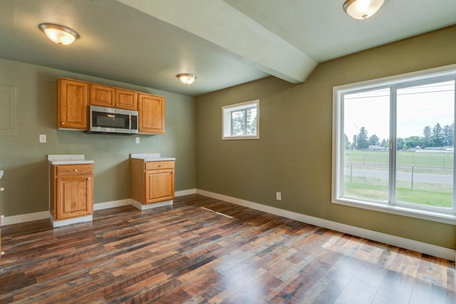 109 E 6th St, Deer Park, WA 99009 - kitchen featuring stainless steel microwave, dark wood-style flooring, light countertops, and brown cabinets