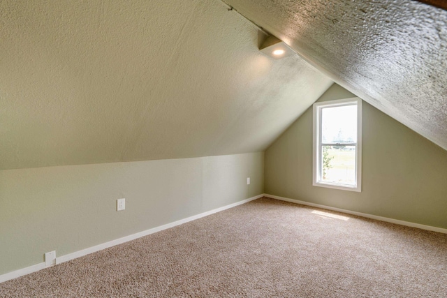 109 E 6th St, Deer Park, WA 99009 - additional living space featuring a textured ceiling, carpet flooring, and vaulted ceiling