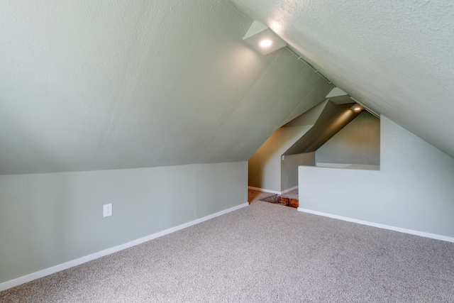 109 E 6th St, Deer Park, WA 99009 - additional living space with a textured ceiling, carpet floors, and lofted ceiling