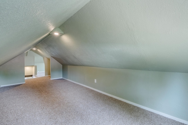 109 E 6th St, Deer Park, WA 99009 - bonus room featuring a textured ceiling, lofted ceiling, and carpet