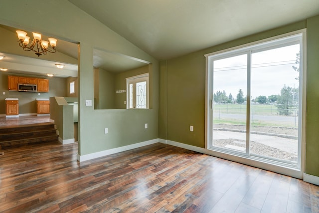 109 E 6th St, Deer Park, WA 99009 - unfurnished living room with dark wood finished floors, vaulted ceiling, and a chandelier
