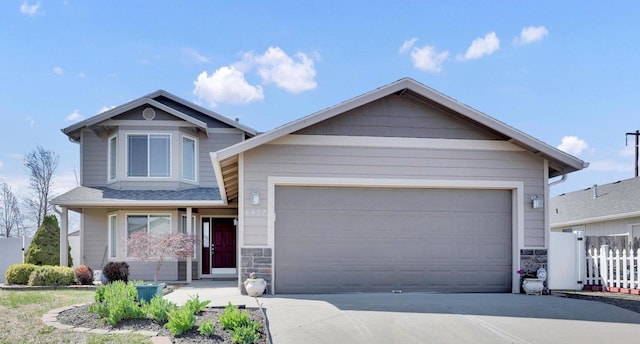 6922 S Lucas St, Cheney, WA 99004 - view of front of property featuring stone siding, a garage, and concrete driveway