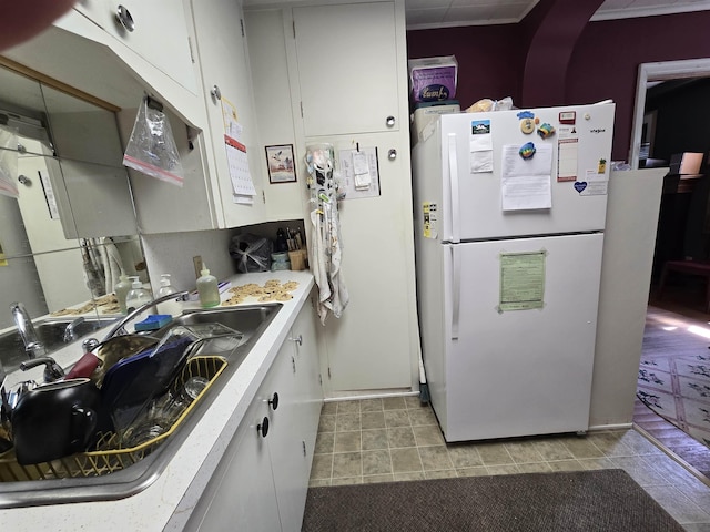 726 W 6th Ave Unit # 205, Spokane, WA 99204 - kitchen with freestanding refrigerator, light countertops, and white cabinetry