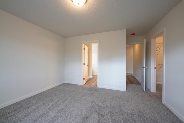 18424 E 1st Ln, Greenacres, WA 99016 - unfurnished bedroom with a spacious closet, carpet flooring, and a closet