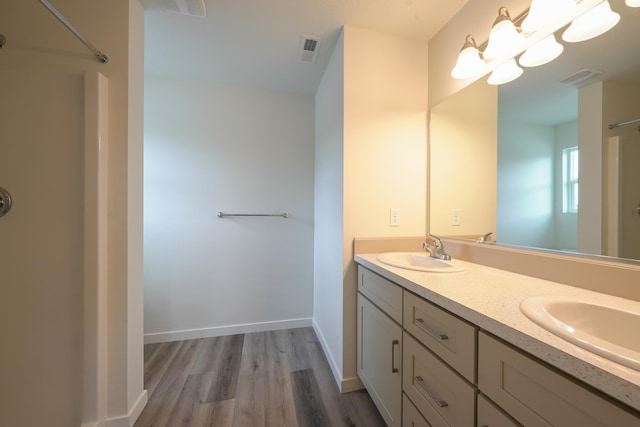 18424 E 1st Ln, Greenacres, WA 99016 - full bathroom with double vanity, wood finished floors, and a shower