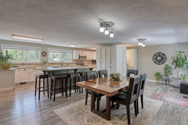 1407 S Shamrock St, Veradale, WA 99037 - dining room with a textured ceiling and light wood-style floors