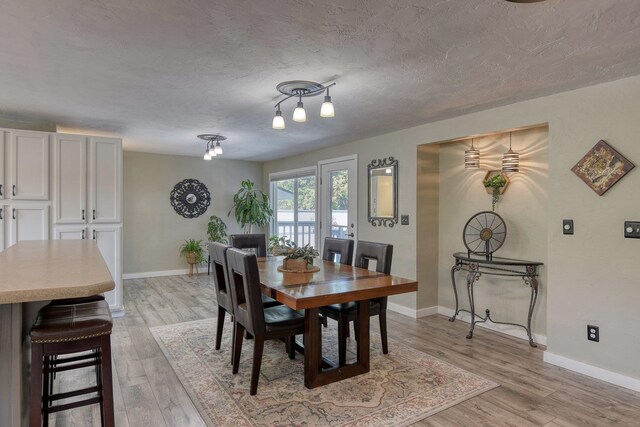 1407 S Shamrock St, Veradale, WA 99037 - dining space featuring light wood finished floors and a textured ceiling