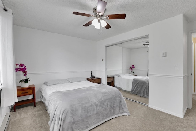 1508 N Arc St, Spokane Valley, WA 99016 - carpeted bedroom with a textured ceiling, a closet, ceiling fan, and a baseboard radiator