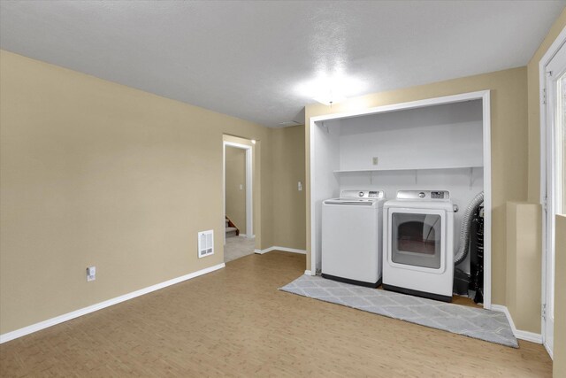 1508 N Arc St, Spokane Valley, WA 99016 - laundry room with independent washer and dryer and wood finished floors