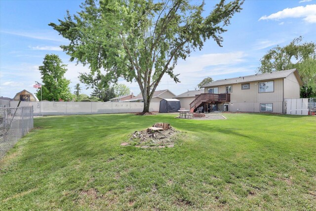 1508 N Arc St, Spokane Valley, WA 99016 - fenced backyard featuring stairway, an outdoor fire pit, a wooden deck, and a storage unit