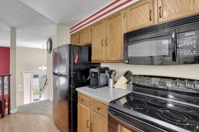 1508 N Arc St, Spokane Valley, WA 99016 - kitchen with black appliances, wood finished floors, light countertops, and a textured ceiling
