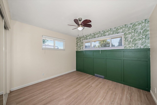 10413 E 6th Ave, Spokane Valley, WA 99206 - unfurnished room with ceiling fan, light wood-type flooring, wallpapered walls, an accent wall, and a decorative wall