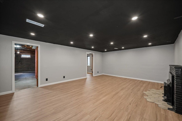 10413 E 6th Ave, Spokane Valley, WA 99206 - unfurnished living room with light wood-type flooring, a brick fireplace, and recessed lighting